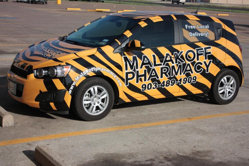 A branded yellow car with Malakoff Pharmacy.